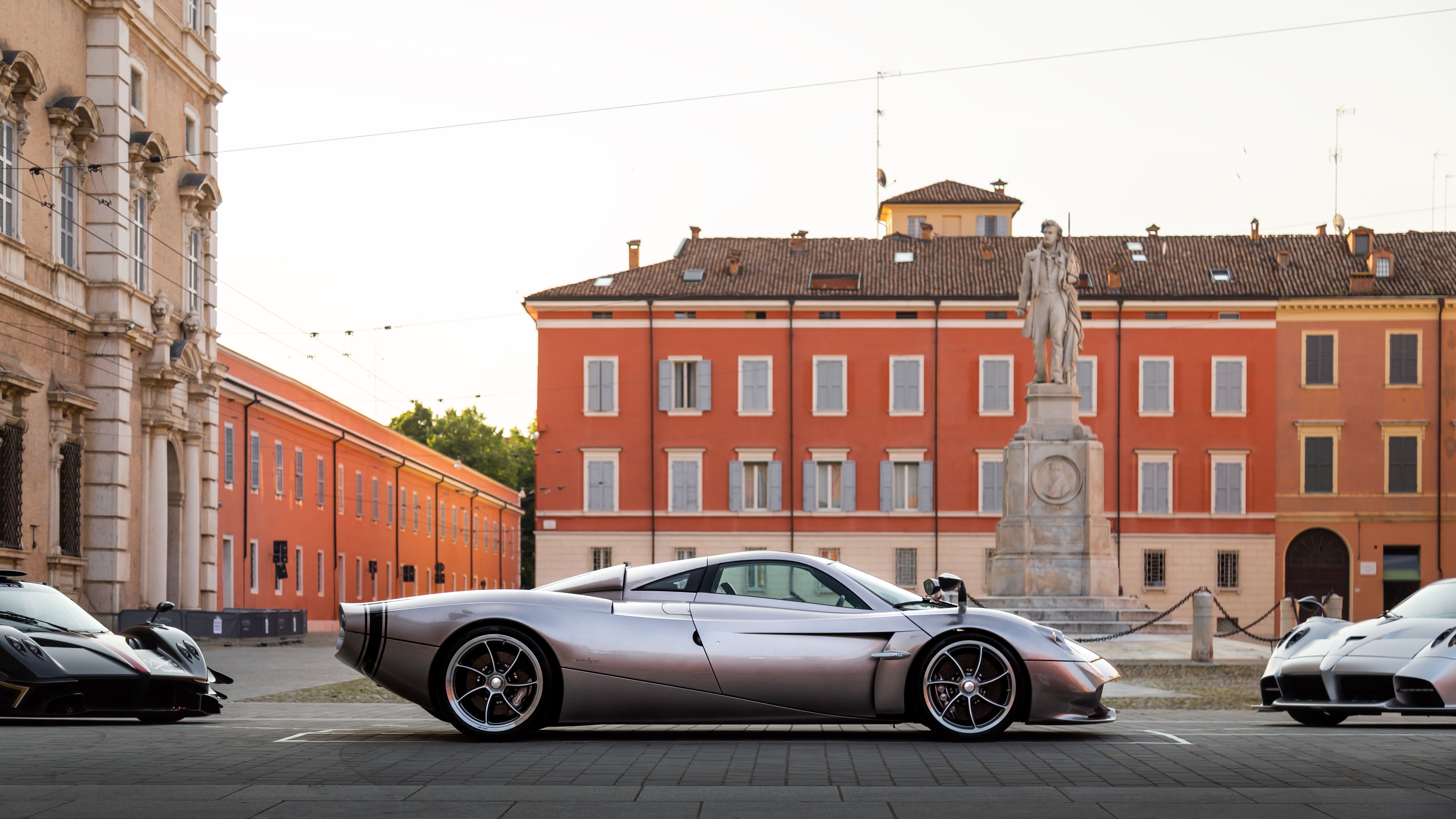Silver Pagani Huayra Codalunga side profile between two other Paganis in Modena